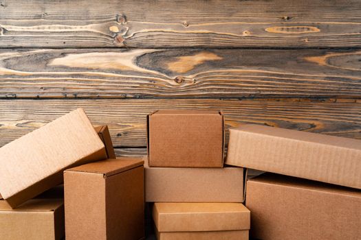 Pile of cardboard boxes on wooden background