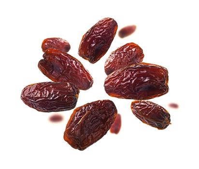 Dried dates levitate on a white background