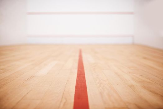 Which team are you on. Shot of an empty squash court.