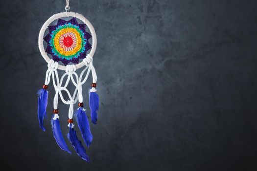 Amulet Dreamcatcher on a black background with free space protecting the sleeper from evil spirits
