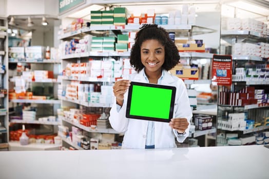 Getting a repeat on your prescription just got easier. Cropped portrait of an attractive young female pharmacist holding up a tablet with a chromakey screen.