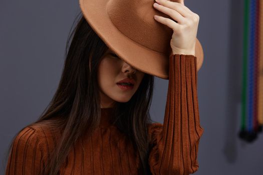 young woman brown hat hand gestures brown sweater fashion emotions Lifestyle