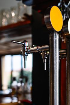 detail of two beer dispensers. Apparatus for dispensing beer in the bar. Drops of water on metal.
