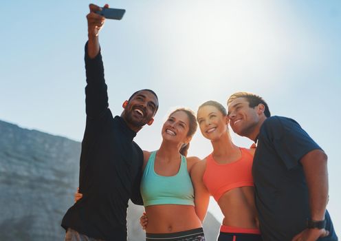 Take this for some fitness inspiration. Shot of a group of friends taking a selfie while out for a workout.
