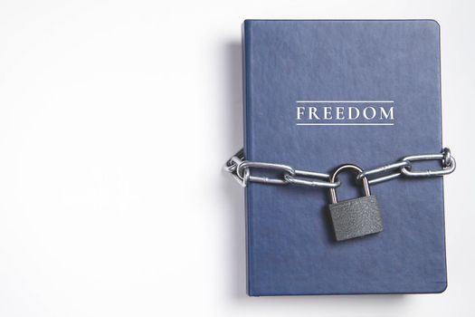 Freedom. Book with lock. A closed book is banned. Chain on the book.