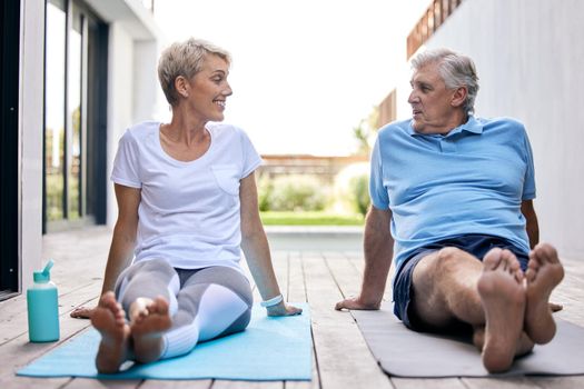Sharing in a more holistic lifestyle together. Shot of a mature couple taking a break while exercising outdoors.