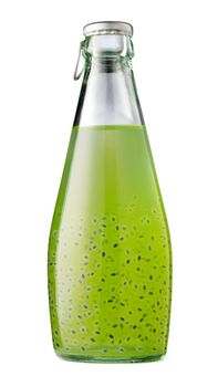 Drink with basil seeds in a glass bottle isolated on white background