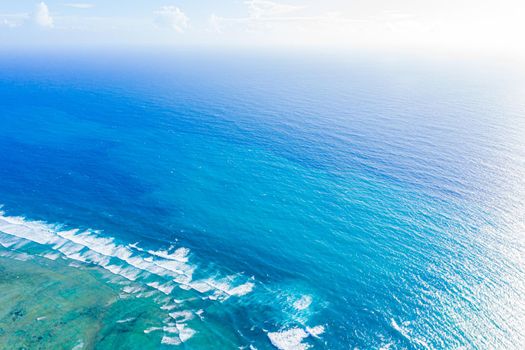 Aerial view to ocean waves. Blue water background. Dramatic colors photo.