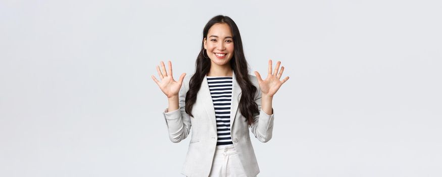 Business, finance and employment, female successful entrepreneurs concept. Smiling elegant asian woman in suit, businesswoman smiling and showing ten fingers, propose good deal