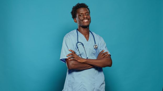 Positive nurse standing with crossed arms and smiling