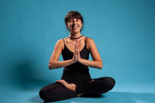 Portrait of personal trainer standing in lotus position