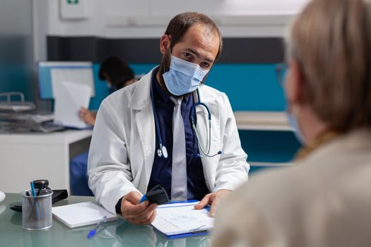 Doctor putting medical seal on prescription paper
