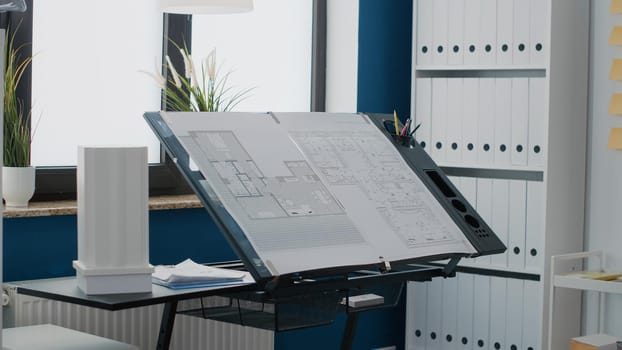 Close up of blueprints plans to design building layout on table in workplace