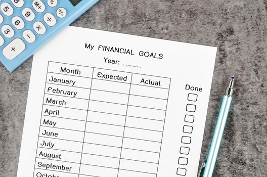 My planning financial goals form and pen with calculator