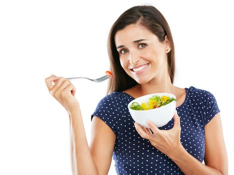 Eat healthy, feel good. Studio portrait of an attractive young woman eating a healthy salad against a white background.