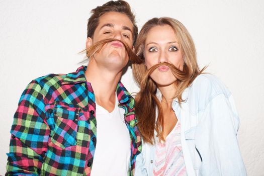 Check our moustaches. Shot of a stylish hipster couple.