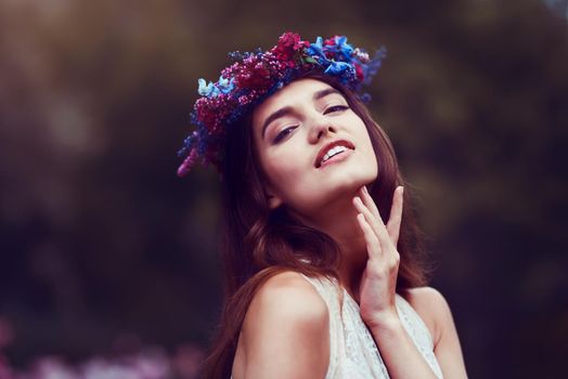 How beautiful to just be. Portrait of a beautiful young woman wearing a floral head wreath outdoors.