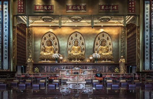 Bangkok, Thailand - Feb 19, 2022 : Architecture of Taiwanese temple-style and Three Buddha images inside Fo Guang San Temple. Selective focus.