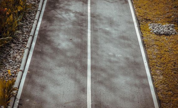 Top view of empty road texture with straight lines in white line on road. 