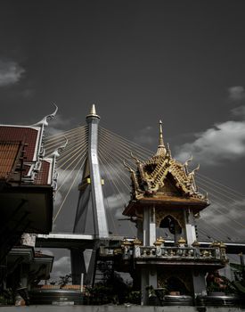 Bangkok, Thailand. Mar - 12, 2022 : Beautiful view of Buddhist thai temple with suspension bridge background can coexist perfectly. No focus, specifically.