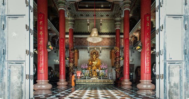 Bangkok, Thailand - Feb 08, 2020 : Architecture of chinese-style temple with the Golden buddha statue inside the Wat Bhoman Khunaram (Bhoman Khunaram Temple). Selective focus.