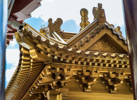 Golden gable roof architecture of Taiwanese temple-style at Fo Guang San Temple. Selective focus.