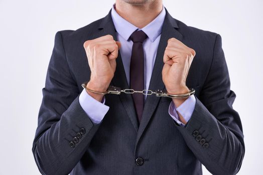 Justice is served. Cropped studio shot of a businessman in handcuffs.