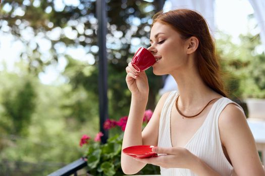 beautiful woman drinking coffee outdoors unaltered