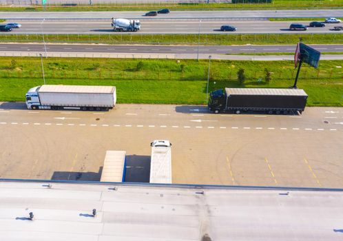Aerial top view of the large logistics park with warehouse, loading hub with many semi-trailers trucks.