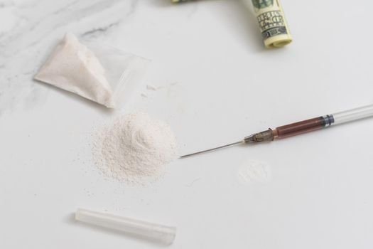 dangerous business - drug laboratory: white powder, syringes and money