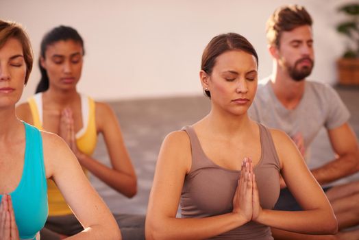 Meditation is the key to energy. A group of people doing yoga together.