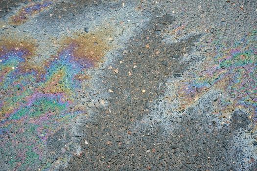 Color Gasoline fuel spots on Asphalt Road as Texture or Background. Environmental pollution concept