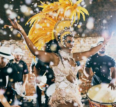 Our night to shine. Cropped shot of a beautiful samba dancer performing in a carnival with her band.