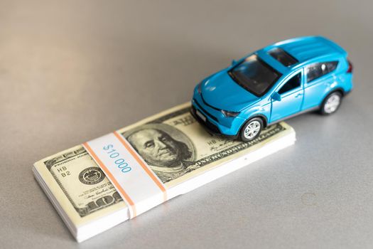 New car with keys and dollar banknotes on white background.