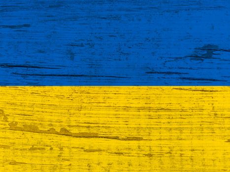 Ukrainian flag painted. Wrinkled blue and yellow colored background