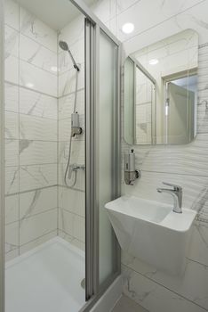 Interior of bright and modern white bathroom. shower cabin
