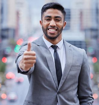 Ill get you the best deal. Shot of a handsome young businessman standing alone and showing a thumbs up.