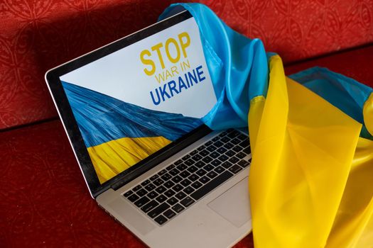 stop war and patriot. laptop, flag of ukraine