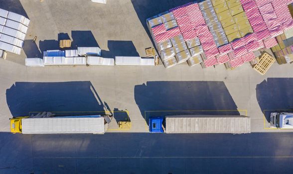 Aerial view of goods warehouse. Logistics center in industrial city zone from drone view. Background texture concept