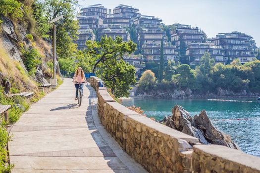 Woman tourist on a bicycle explores Budva in Montenegro. Cycling in Montenegro concept