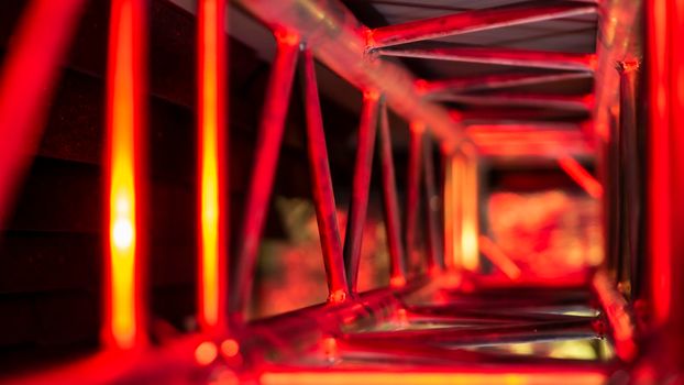 aluminum truss for lighting equipment illuminated with red light. color