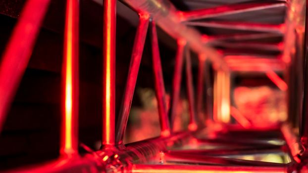 aluminum truss for lighting equipment illuminated with red light. color