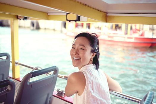 Its the perfect day for a boat ride. Cropped portrait of an attractive young woman exploring the city alone on a ferry during the day.