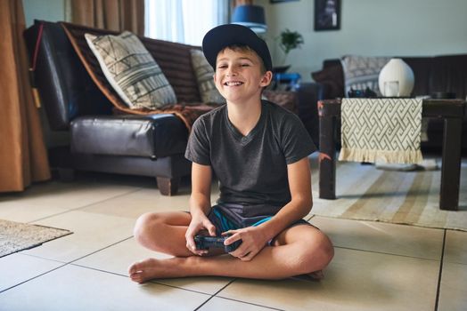I love this game. Full length portrait of a young boy playing video games at home.