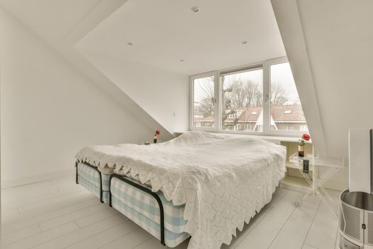 Snow-white bedroom with double bed