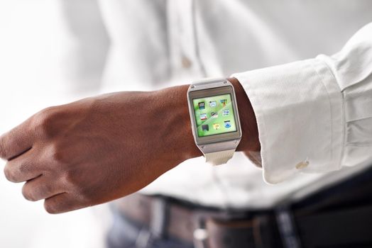 Taking technology on the go. Cropped view of a man wearing a smartwatch - All screen content is designed by us and not copyrighted by others.