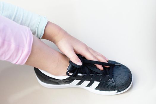 Bangkok ,Thailand,July 18 ,2018-kid hand touch black sneaker shoes brand Adidas