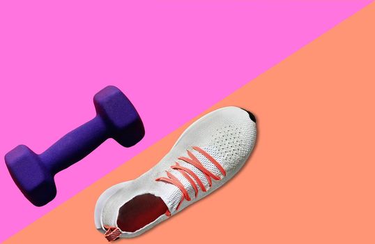 shoe and dumbbell for fitness on color background