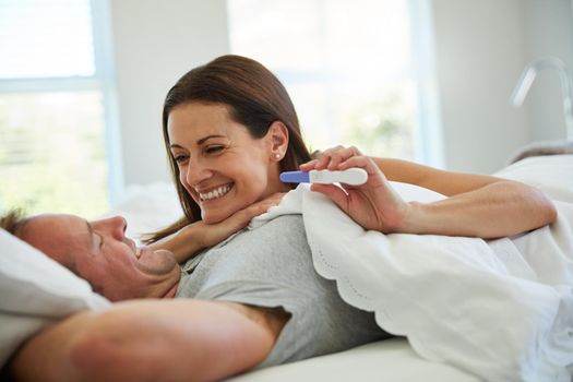 Theres a bundle of joy on its way. Shot of a mature couple feeling excited after taking a home pregnancy test.