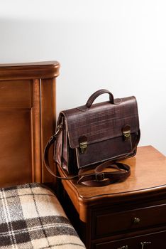 Brown leather briefcase with two locks. hotel room photo